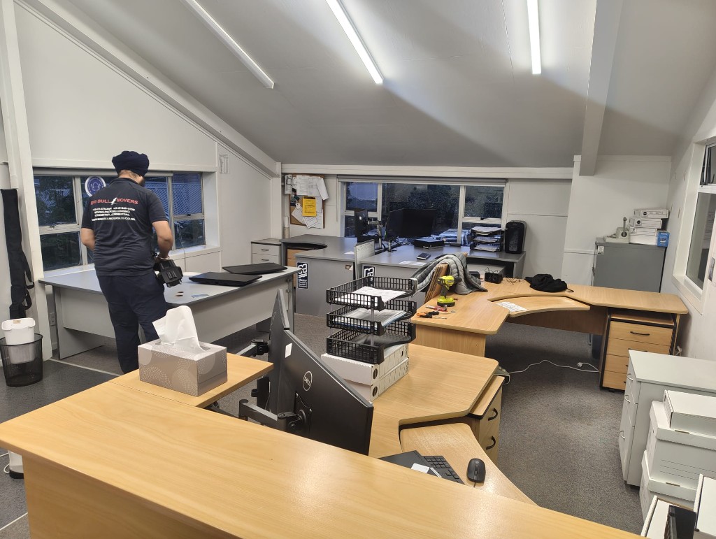 Office relocation Auckland — Big Bull Movers setting up an office workspace during a commercial move