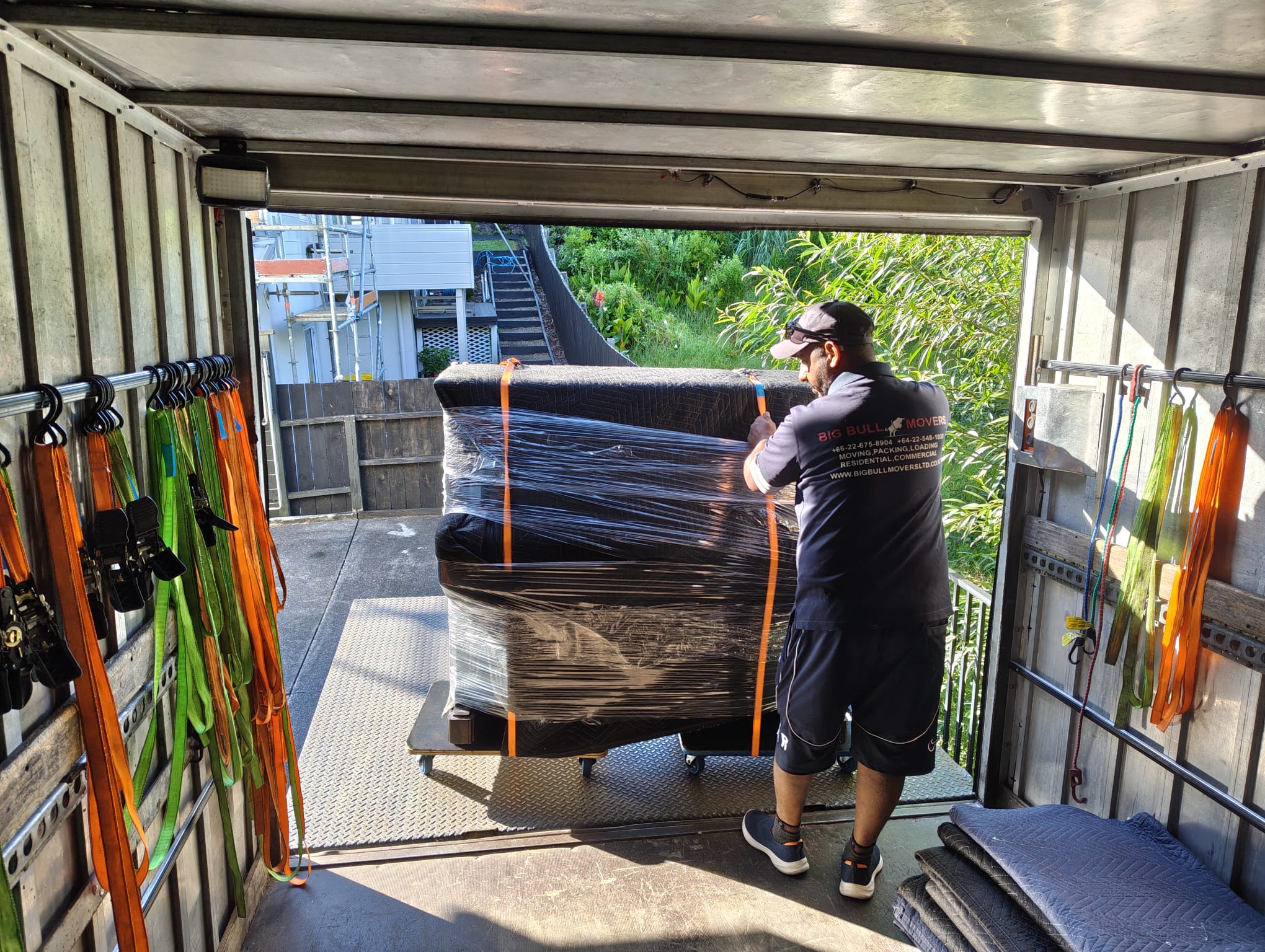 Professional piano movers carefully relocating a piano in Auckland
